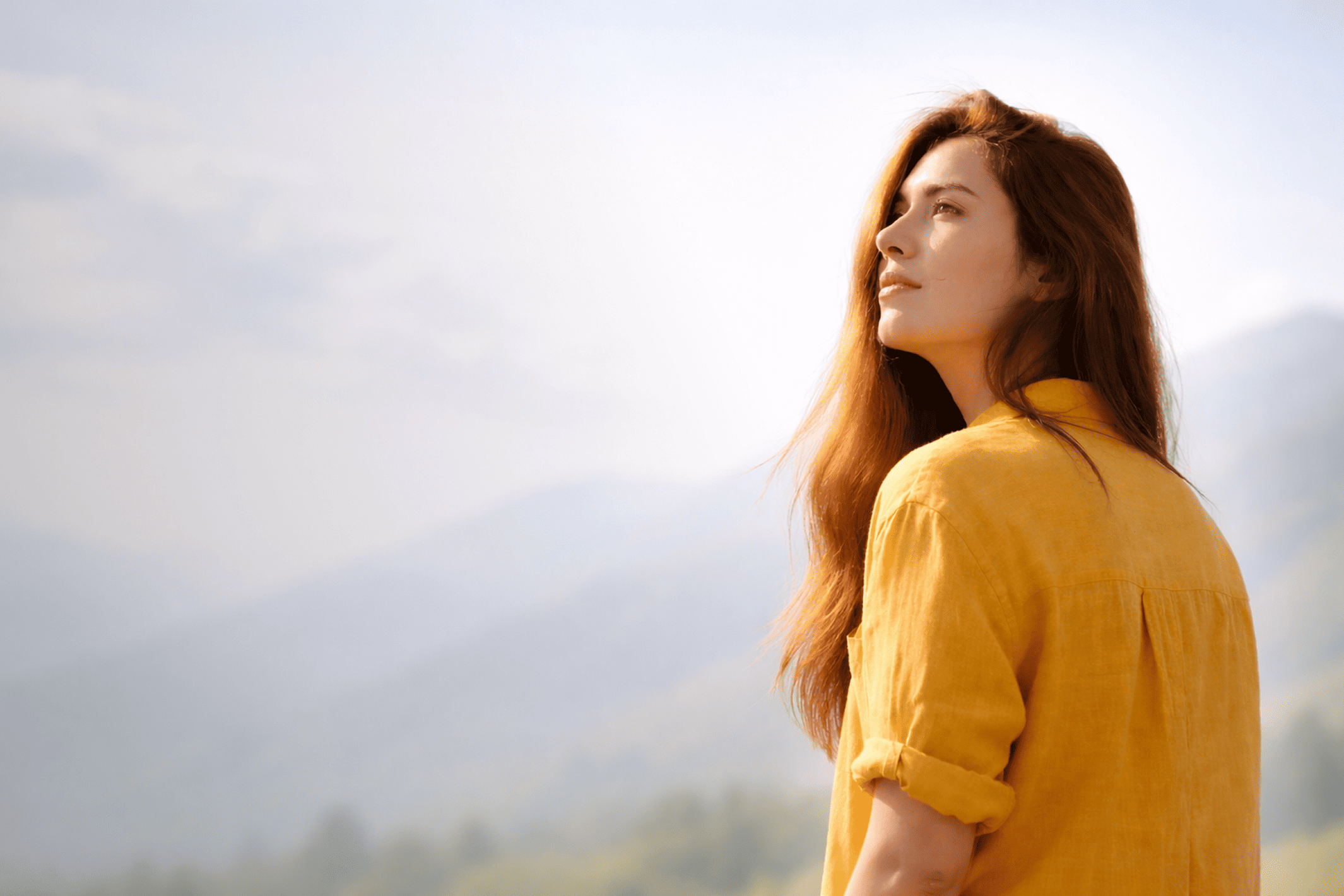 Woman contemplating a landscape, holistic health with Axo Longevity
